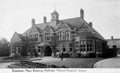 Historical black and white photograph of a large building labeled 'Entrance, Main Building, Hellingly Mental Hospital, Sussex'.