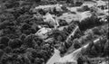 Aerial view of a residential area with houses surrounded by trees