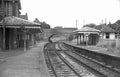 Vintage black and white photograph of a railway station with tracks and platforms.