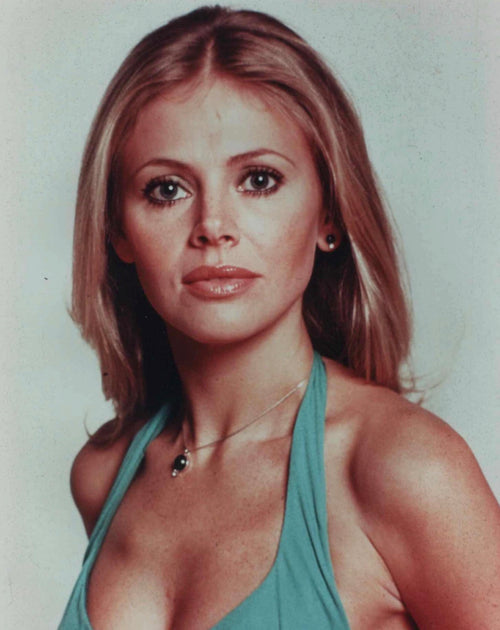 Woman wearing a green halter top against a plain background