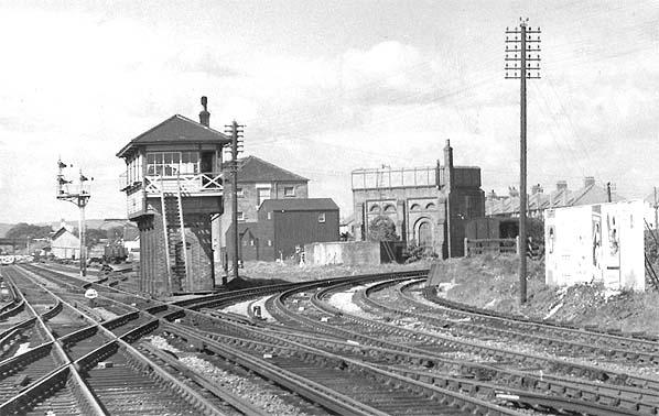 Vintage black and white photograph of a railway junction with signal boxes and tracks.