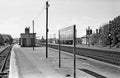 Vintage black and white photograph of a train station platform with 'Polegate' sign.