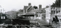Vintage black and white photograph of a railway station with signal box and platform.