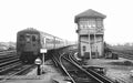 Vintage black and white photograph of a train on tracks with a signal tower.
